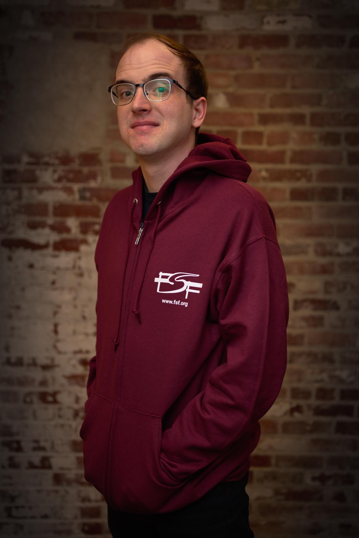 Greg wearing the maroon Free Software Free Society hoodie