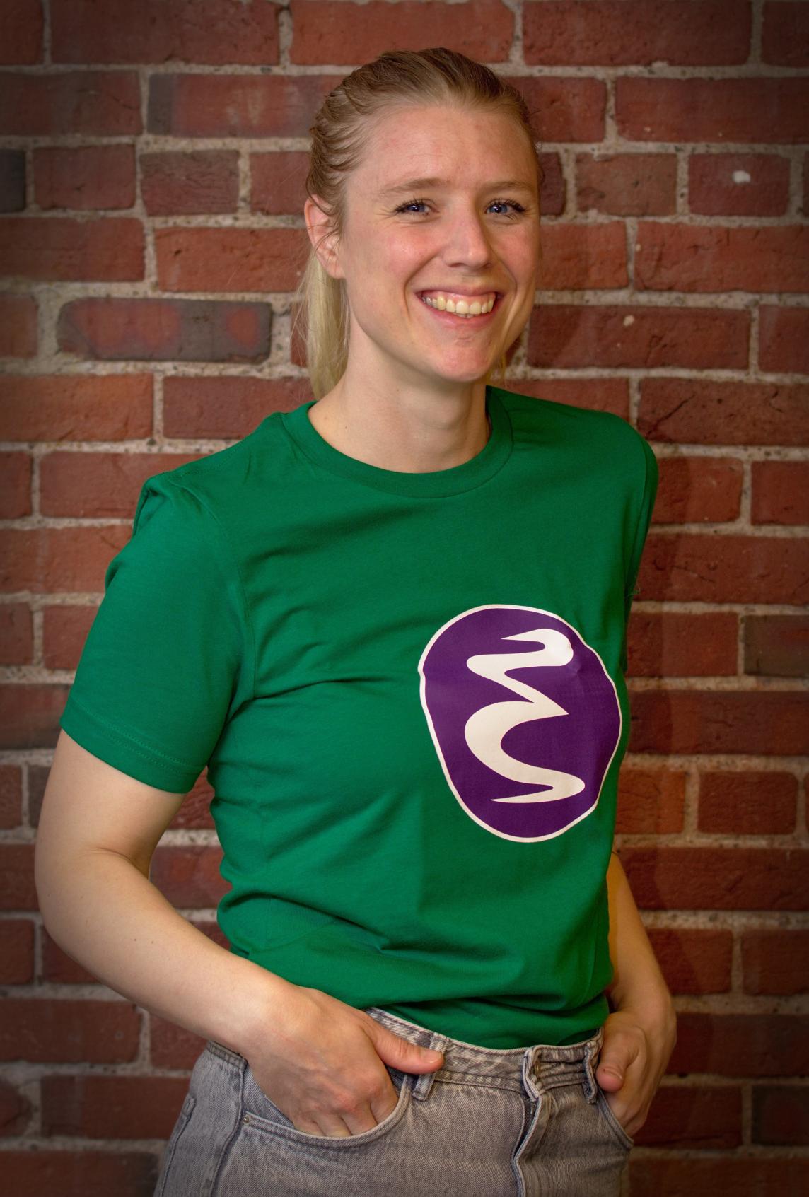 Zoë wearing a green and purple Emacs logo t-shirt