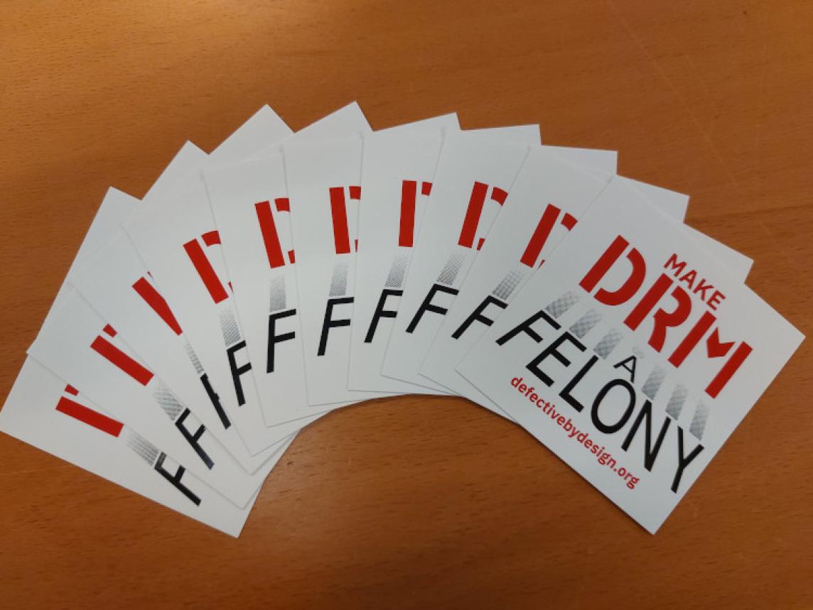 Make DRM A Felony stickers arrayed in a fan like shape