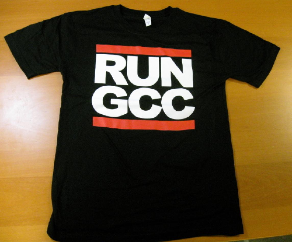 A black t-shirt with white text saying RUN GCC