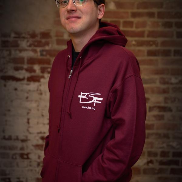 Greg wearing the maroon Free Software Free Society hoodie