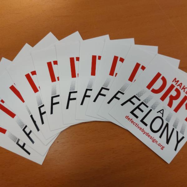Make DRM A Felony stickers arrayed in a fan like shape