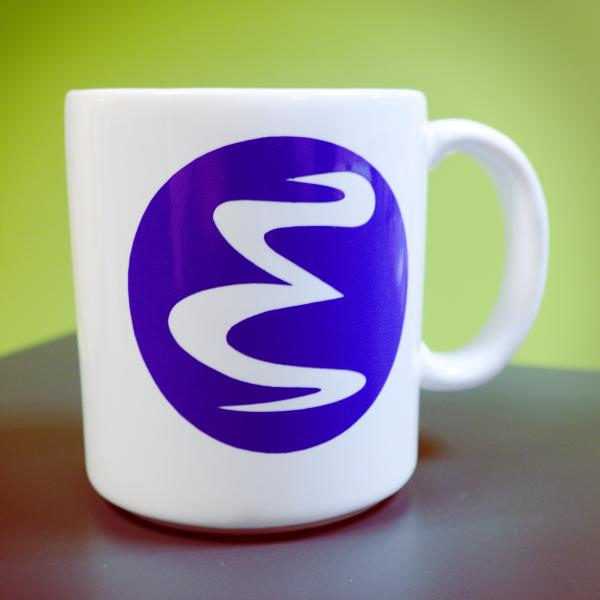 A white mug with a Purple Emacs logo