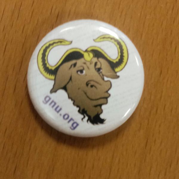 A pin showing a gnu head and the text "gnu.org"