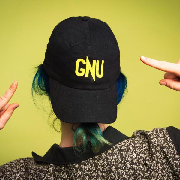 View from behind someone wearing a backwards hat with the word "GNU"
